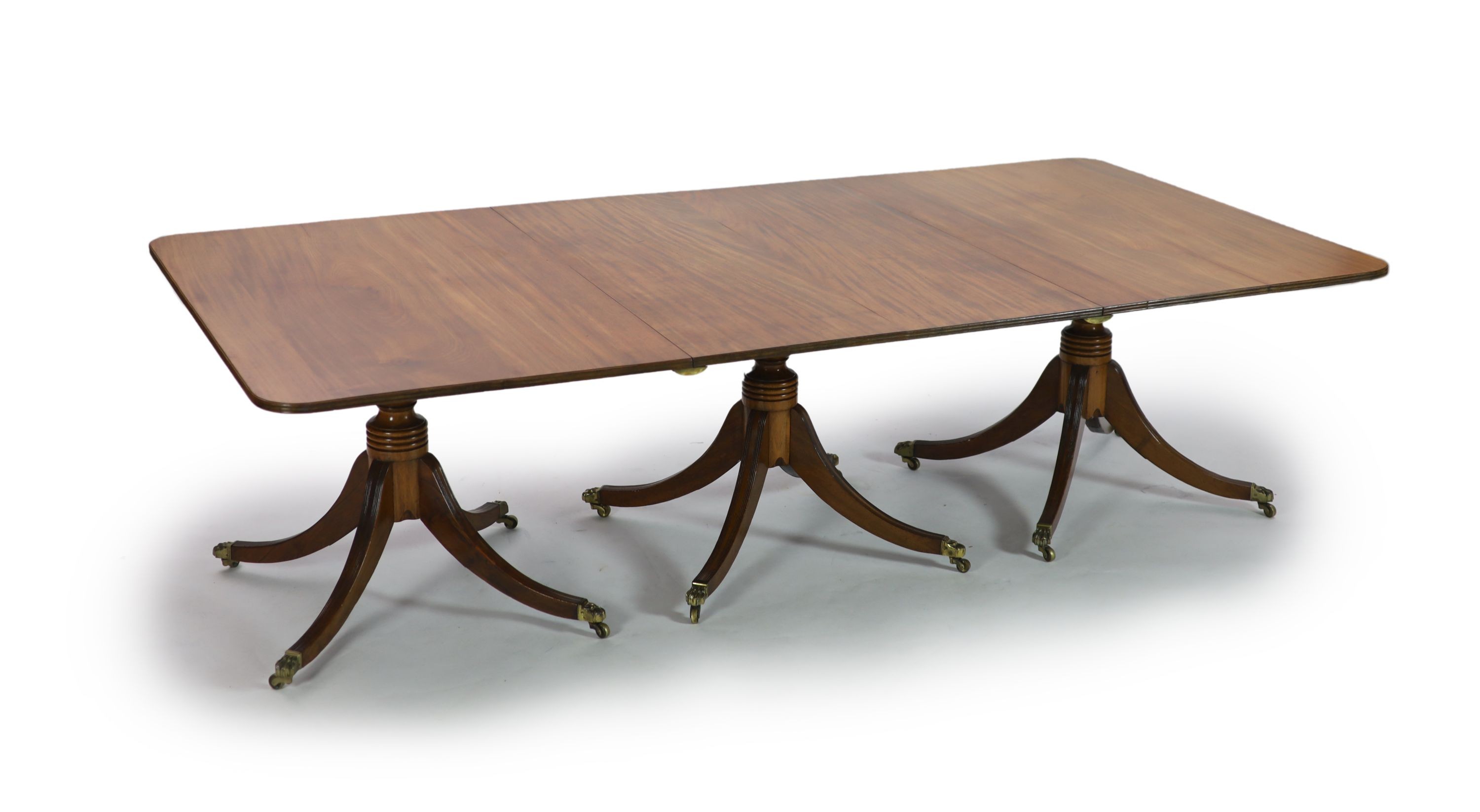 A Regency and later mahogany triple pedestal dining table, W.258cm D.132cm Extends to 362cm H.74cm